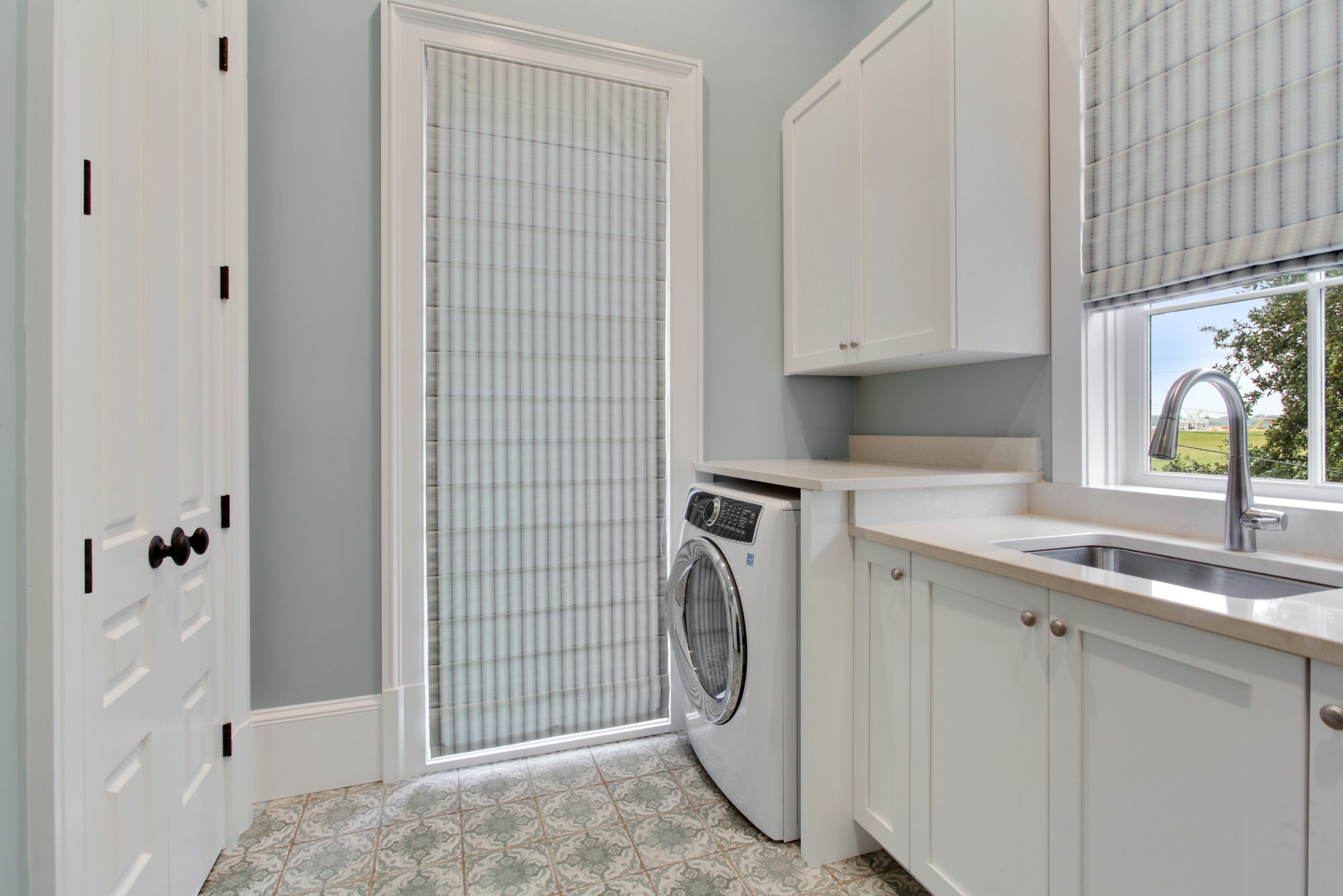 Laundry Room of Audubon House luxury new construction custom home designed and built by DMG