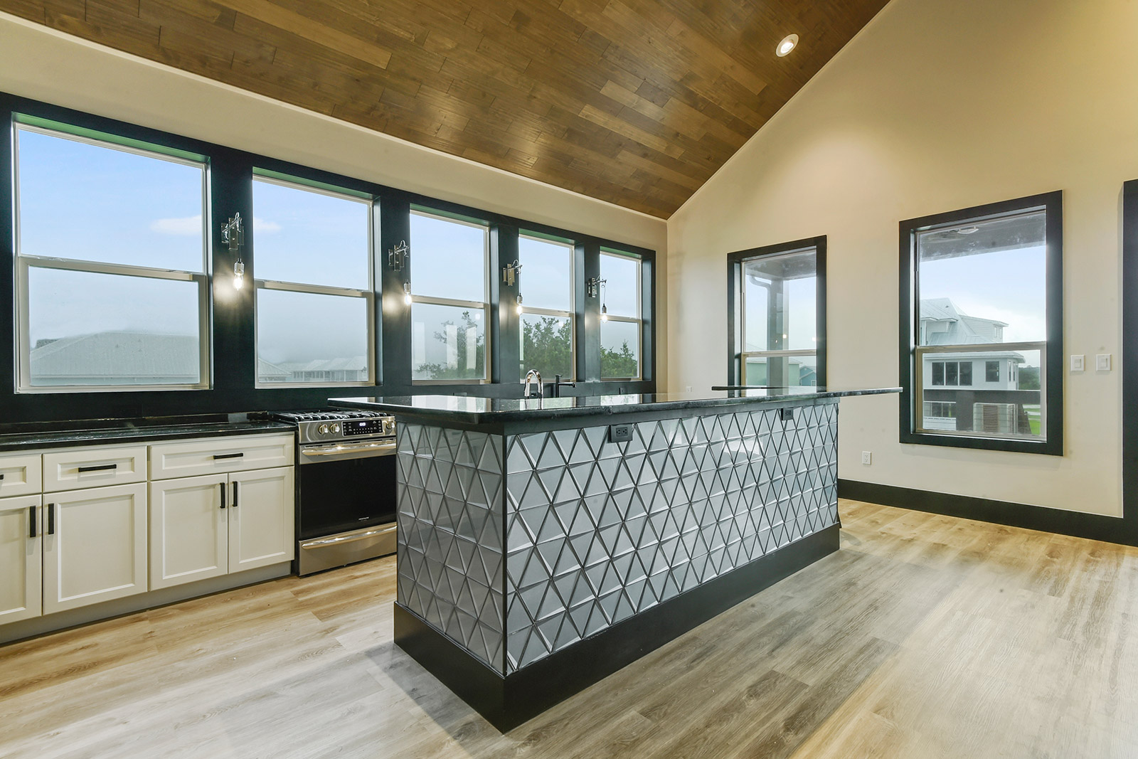 Kitchen with mirror island in Borneo House luxury new construction custom home designed and built by DMG