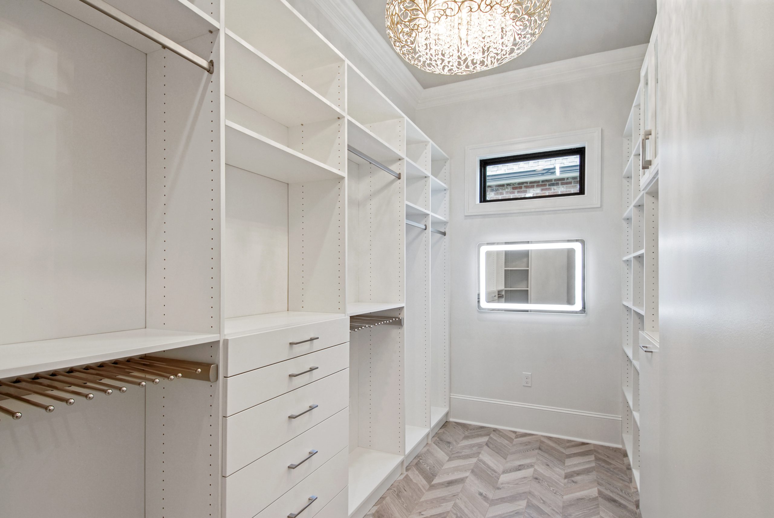 Primary suite custom closet in Dogwood House luxury new construction home designed and built by DMG