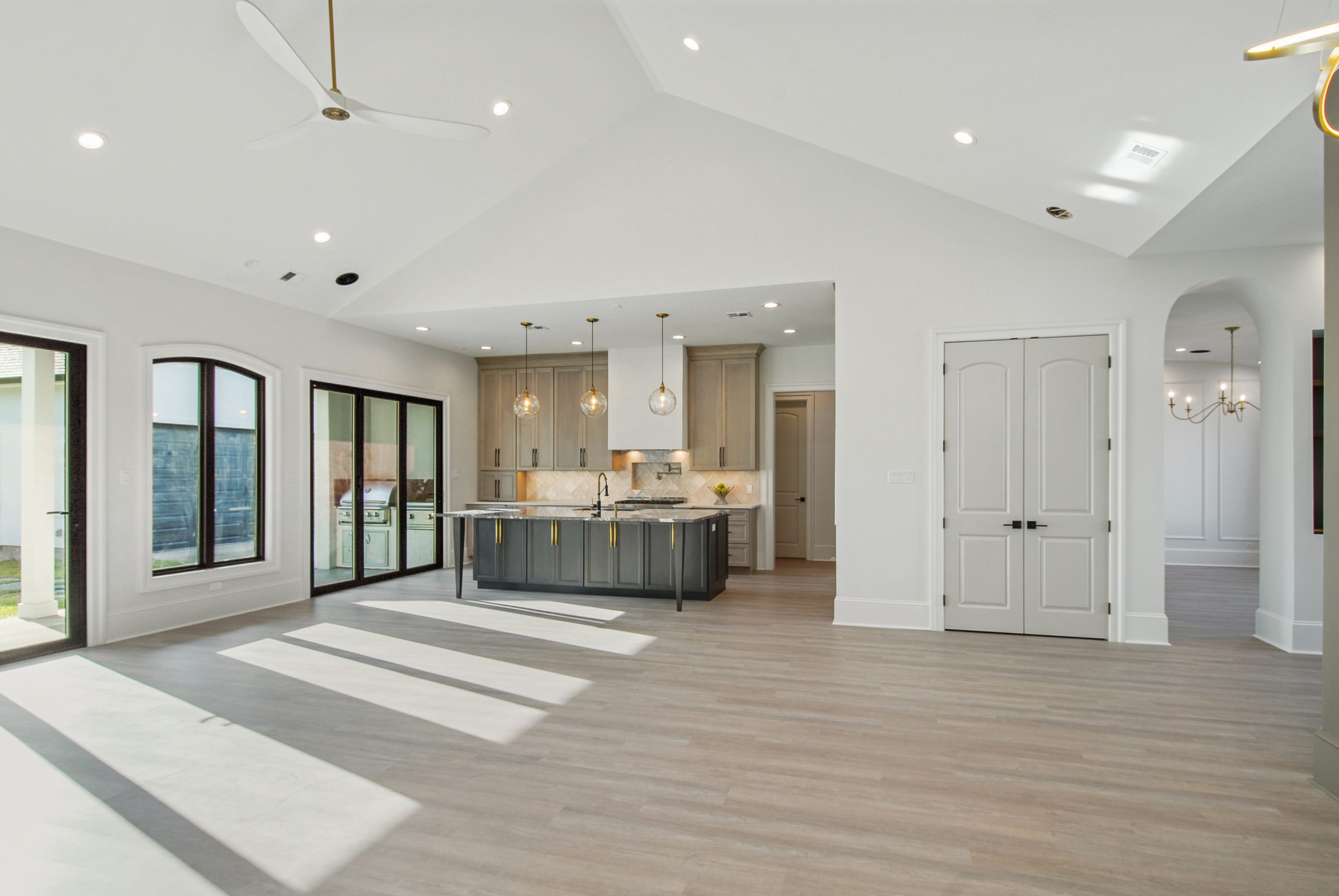 Open concept kitchen and living room of Dogwood House new construction luxury home designed and built by DMG