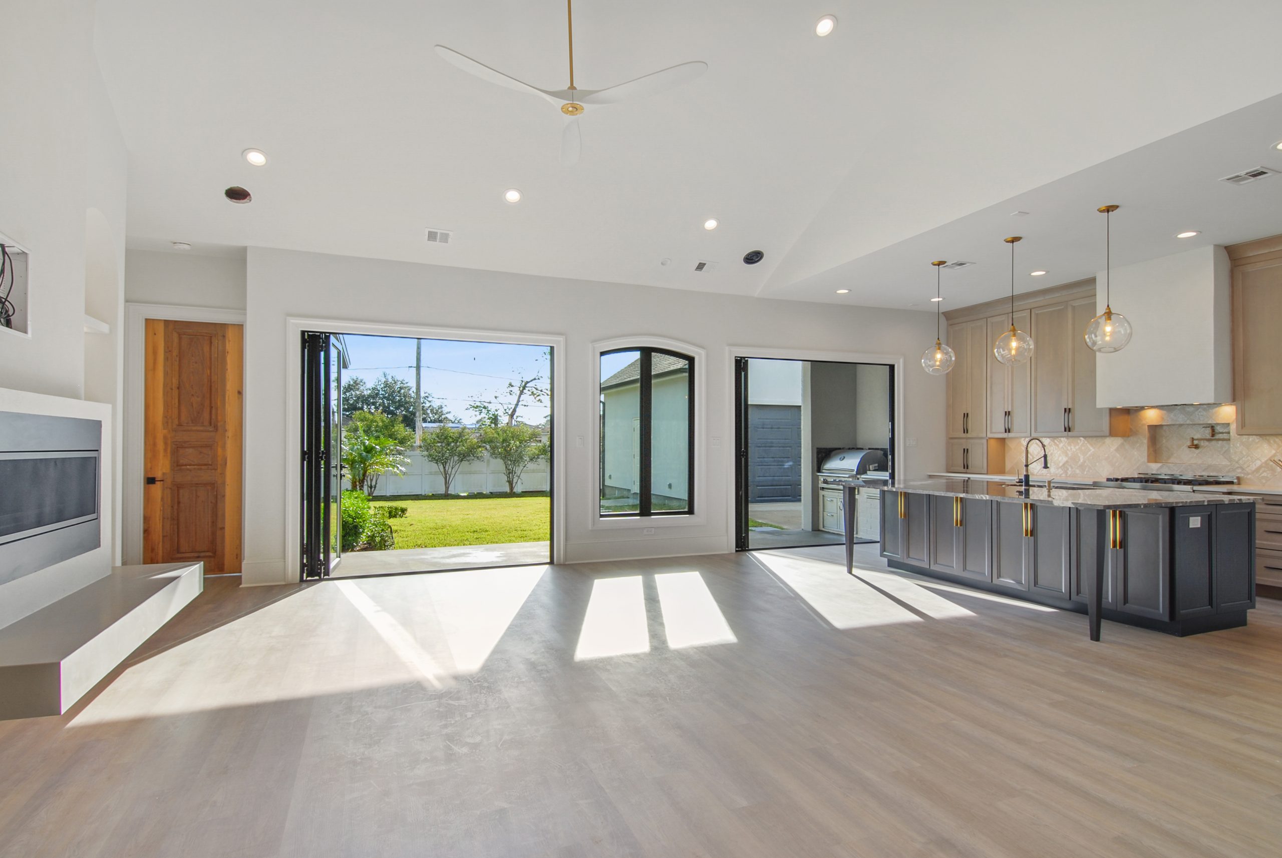 Open concept kitchen and living room of Dogwood House new construction luxury home designed and built by DMG