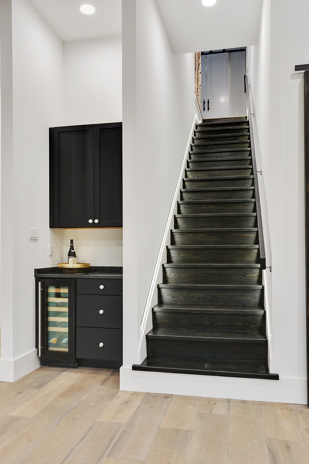 Modern Stairway with custom birch tree railing in Elmeer House luxury new construction home designed and built by DMG Design+Build