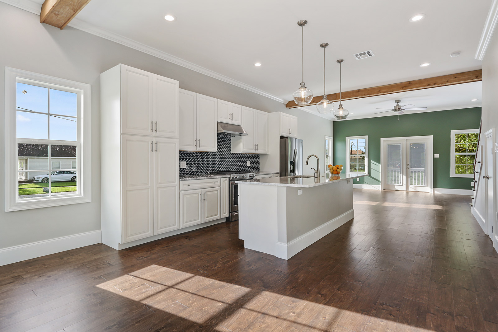 Open-concept kitchen and living room in Patterson House luxury new construction custom home designed and built by DMG