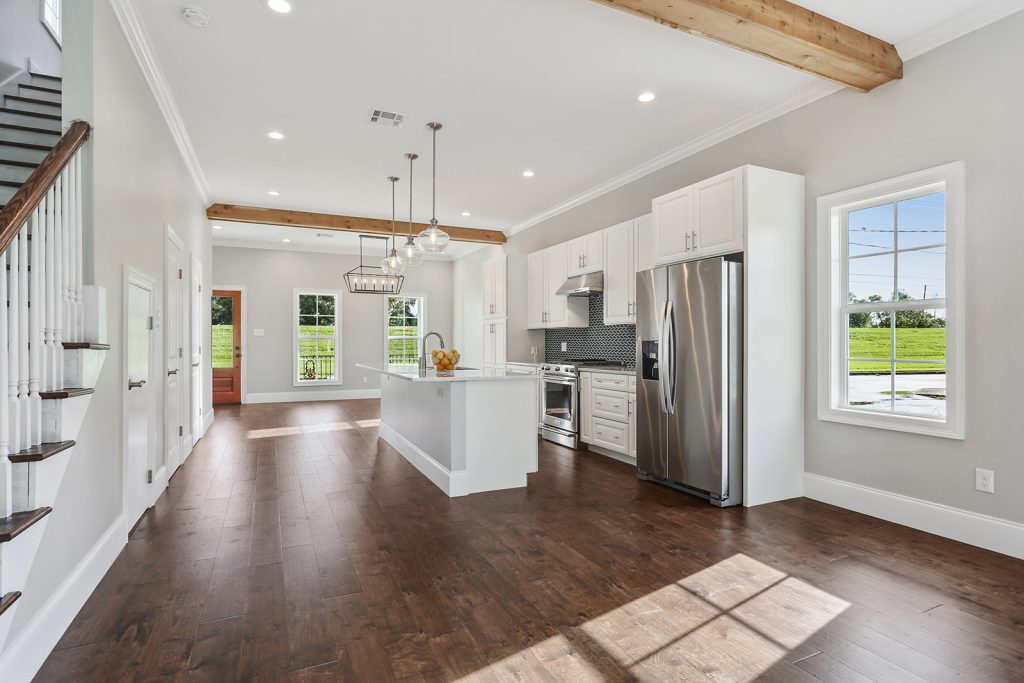 Open-concept kitchen, dining, and living area in Patterson House luxury new construction custom home designed and built by DMG