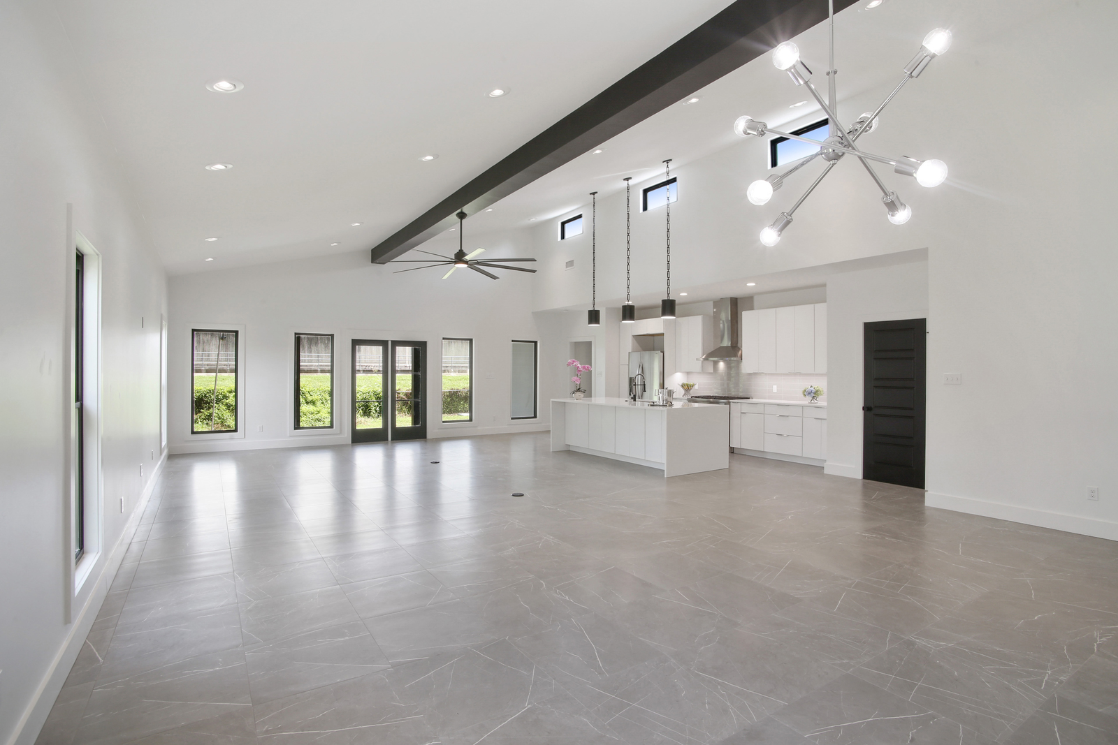 Open concept kitchen and living room of Pratt House new construction custom home designed and sustainably built by DMG Design+Build