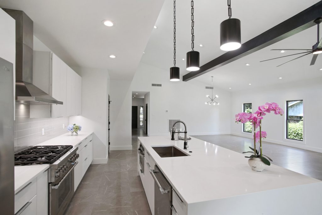 Open concept kitchen and living area of Pratt House new construction custom home designed and built by DMG Design+Build