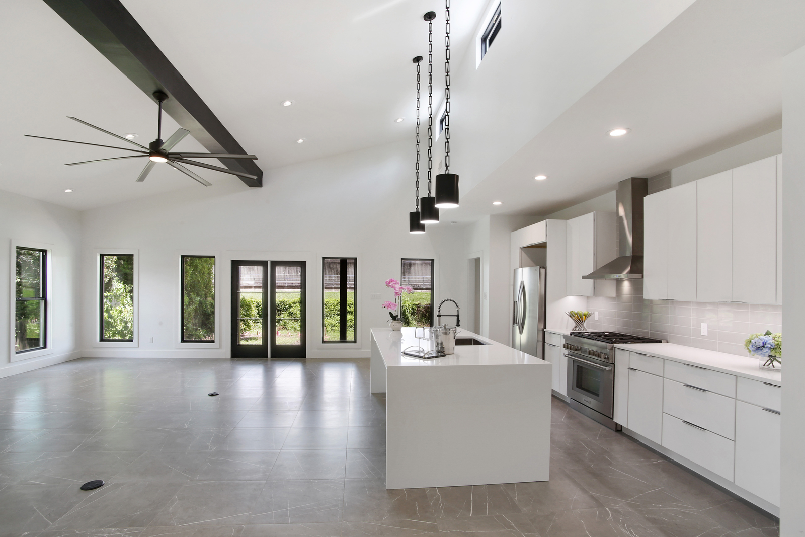 Open concept kitchen and living area of Pratt House new construction custom home designed and built by DMG Design+Build