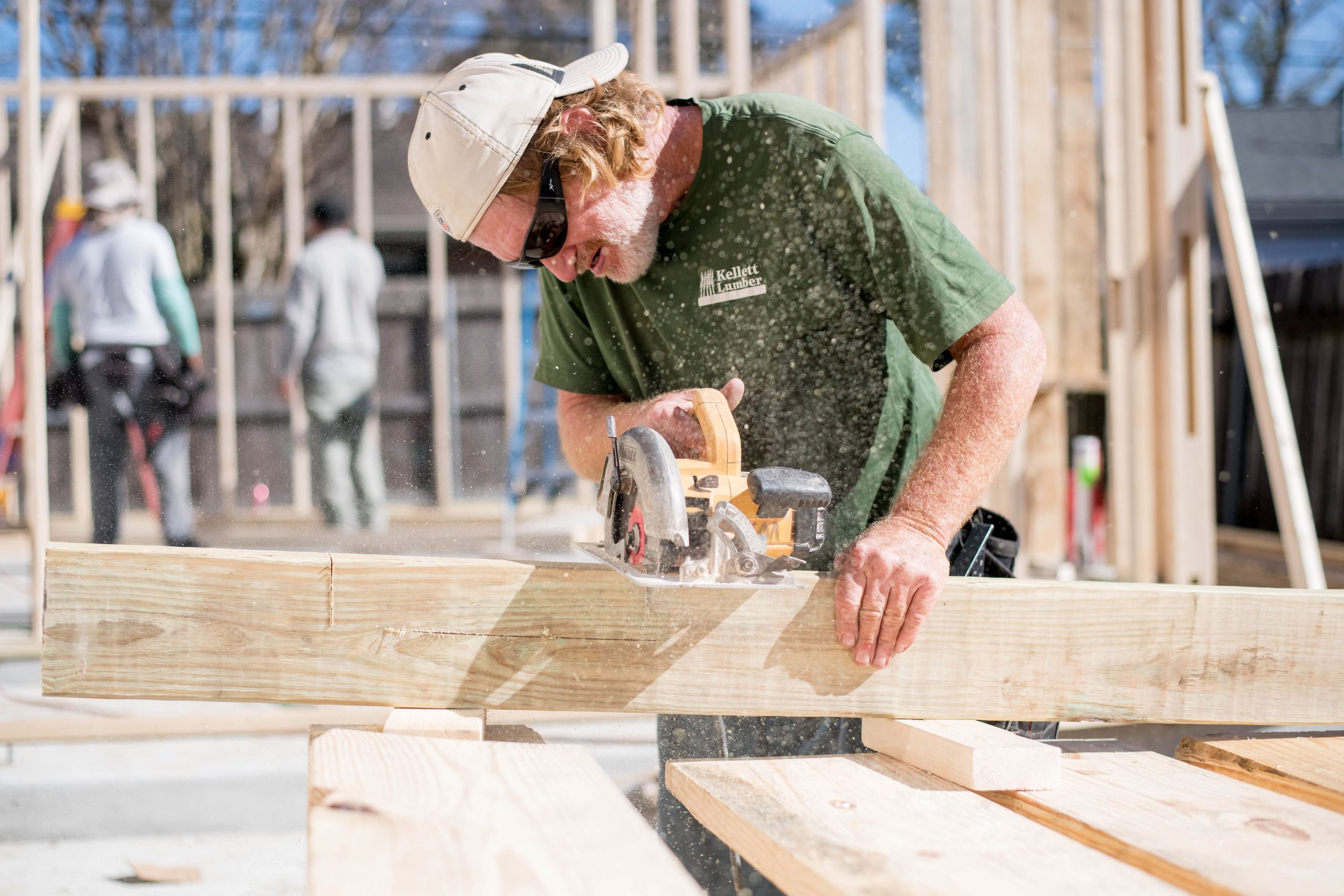 DMG Construction Worker Cutting a Board